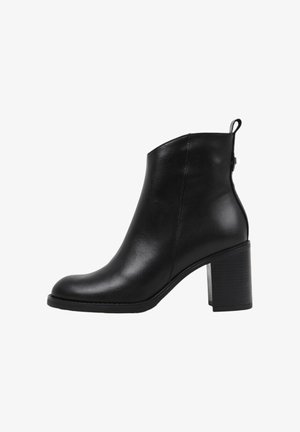 Botín negro hecho de cuero suave, con punta redondeada, cremallera en la parte posterior y un tacón grueso y texturizado.