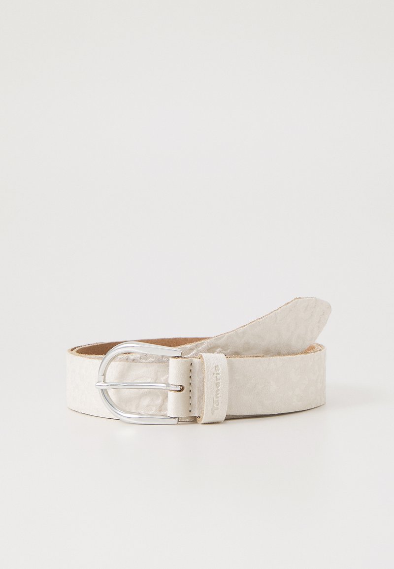 Beige läderskärp med ett präglat mönster, silverfärgad metallspänne och en något avsmalnande ände. Inuti har det en slät brun finish.