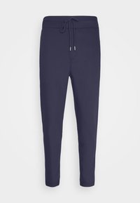 Pantalons de survêtement ajustés bleu marine avec une taille élastique et un cordon de serrage. Fabriqués en tissu doux avec une texture lisse, sans motifs visibles.