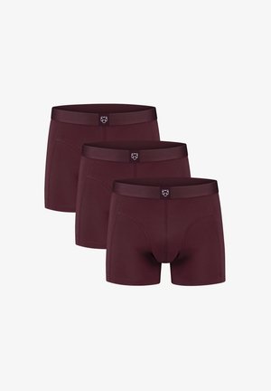 Bordó boxer alsónadrág, három darabos csomagban, puha, logós derékpánttal. Szoros szabással és sima textúrával tervezve.