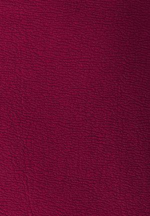 Textured fabric in deep burgundy with a crinkled pattern, soft to the touch, featuring uneven surface lines across the material.