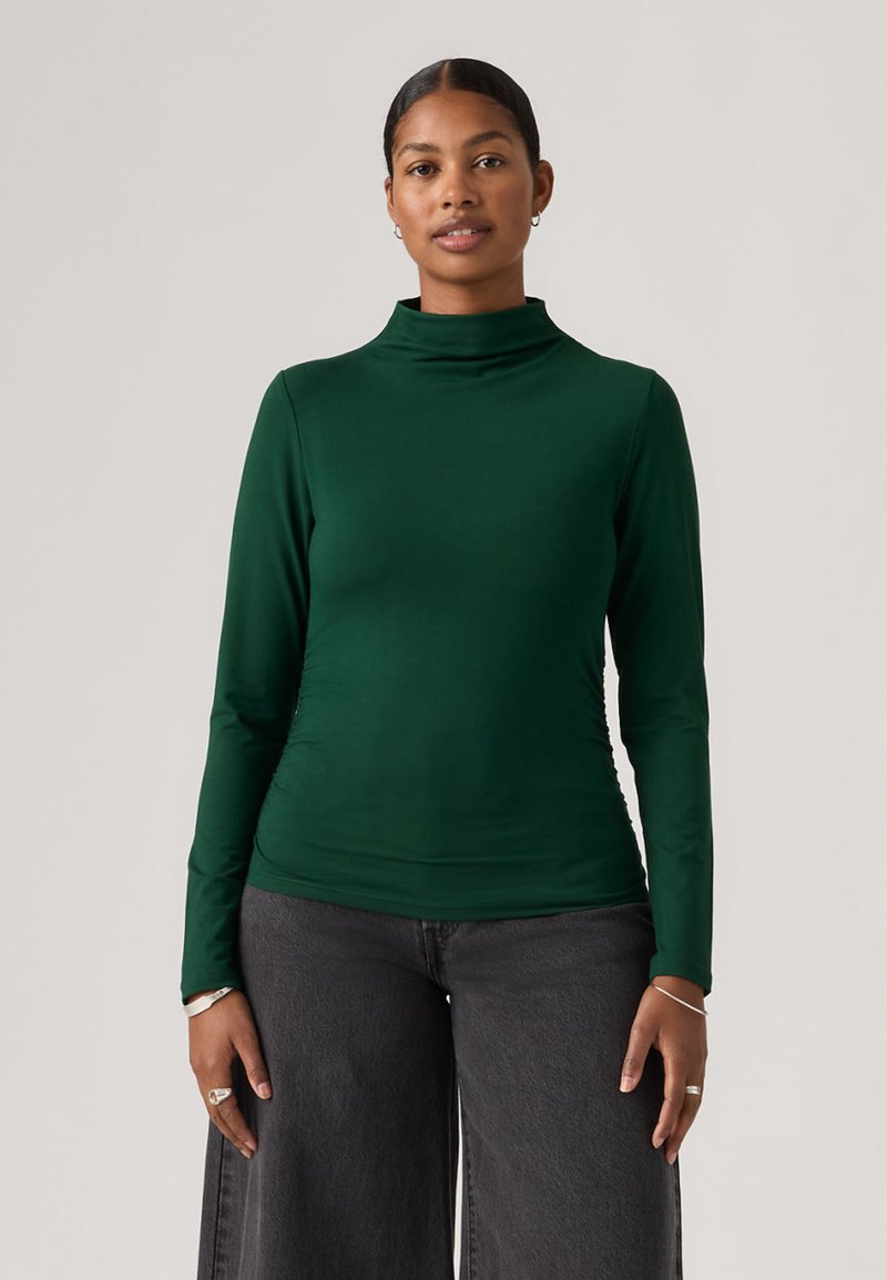 Groen nauwsluitend coltrui-top met lange mouwen, gemaakt van gladde stof en met een aansluitende pasvorm. Heeft een hoge hals en geplooide details aan de zijkant.