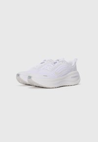 Pair of white Nike ZoomX running shoes with thick soles, visible swoosh logos, and lace-up design on a plain white background.