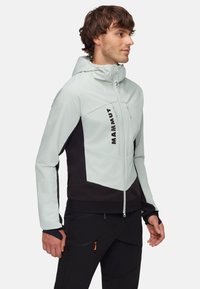 Hooded jacka i ljusgrått och svart, med dragkedja fram, sidofickor, elastiska ärmslut och logotypdetalj på bröstet.