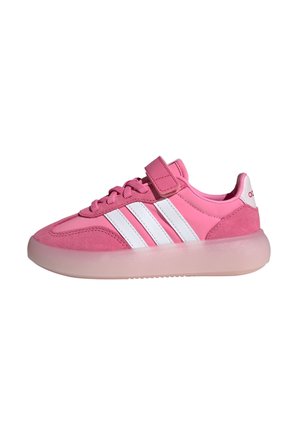 Pink athletic shoe featuring suede and synthetic upper, three white stripes, and a Velcro strap. Translucent pink rubber sole.