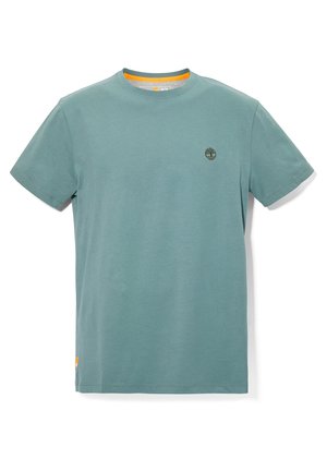 Miętowa koszulka z krótkim rękawem i okrągłym dekoltem, z małym logo drzewa po lewej stronie klatki piersiowej oraz pomarańczowym wykończeniem wewnątrz kołnierzyka i na krawędzi.