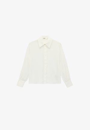 Blouse blanche à manches longues avec un col pointu, des poignets boutonnés et des boutons avant dissimulés.