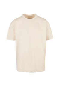 Beige cotton t-shirt with a crew neckline, short sleeves, and a relaxed fit; smooth texture with no visible patterns or accents.