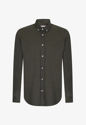 Chemise en velours côtelé vert foncé à manches longues, col boutonné et boutons blancs. Elle présente un petit logo brodé sur la poitrine.