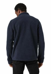Navy fleece jacket with a high collar, soft texture, and long sleeves. Features a relaxed fit and minimal seams for comfort.