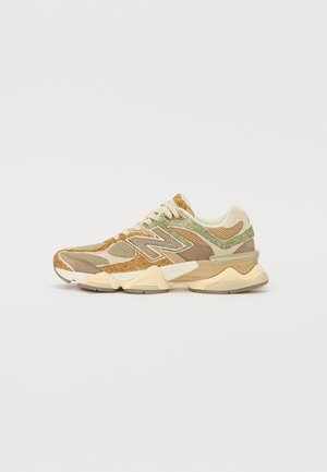 Sneakers with a mesh upper in beige, olive, and brown. Features a textured design, padded collar, and a chunky light tan sole.