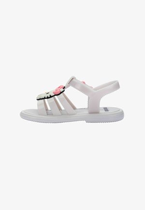 Sandale blanche pour enfant avec sangle réglable et décoration du visage de Hello Kitty sur les lanières avant.