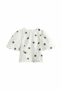 Valkoinen pusero, jossa isot mustat pilkulliset täplät ja leveät, puhkeavat lyhyet hihat. Siinä on pyöreä pääntie ja takana vetoketjukiinnitys.