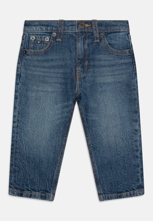 Dongeribukser i mørkeblå med en falmet finish. Har fem lommer, en øverste knap og kontrastsøm langs sømmene.