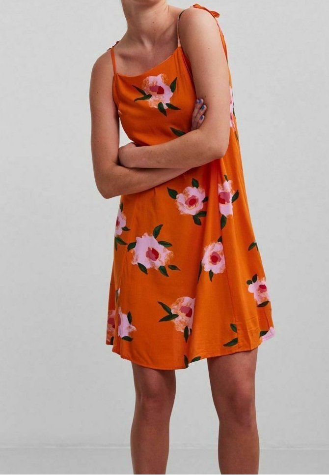 Orange sleeveless dress featuring a floral pattern with pink flowers and green leaves, made from soft fabric with a relaxed fit.