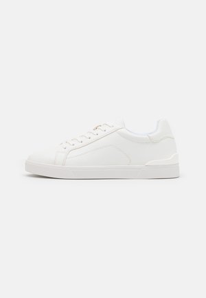 White synthetic sneakers with a smooth texture, round toe, lace-up front, subtle stitching details, and rubber soles. Accented with light blue around the collar.