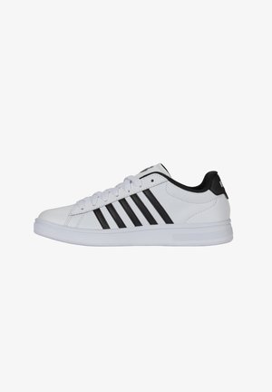 White athletic shoe with black stripes, made from synthetic leather. Round toe, flat sole, and lace-up design. Minimal branding on the heel.