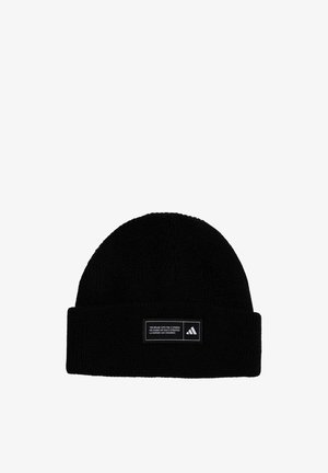 Black knitted beanie with a folded cuff, featuring a rectangular logo patch with text and a three stripes design. Soft texture.