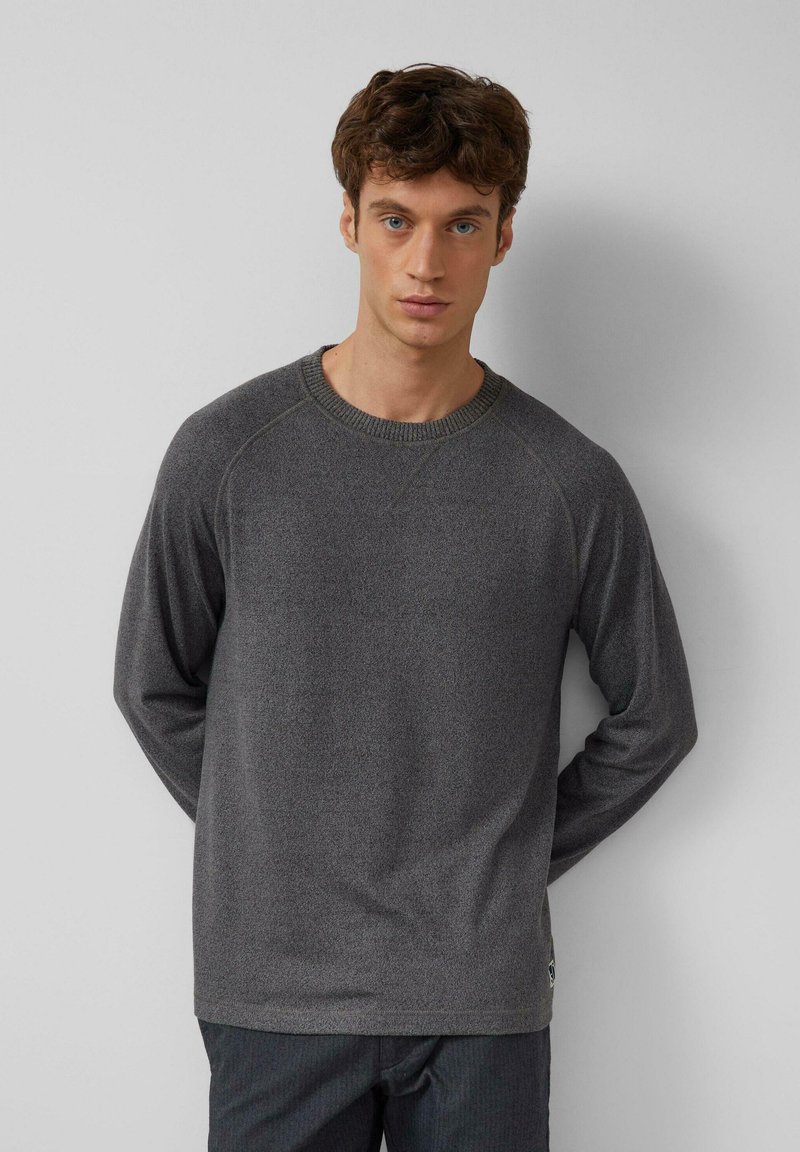 Gray long-sleeve sweater with a ribbed crew neckline and raglan sleeves. Soft texture, simple design, and subtle stitching details.