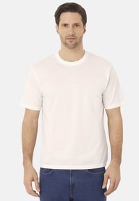 Bílá bavlněná tričko s krátkými rukávy, kulatým výstřihem a volným střihem. Tkanina vypadá hladce a lehce, bez vzorů.