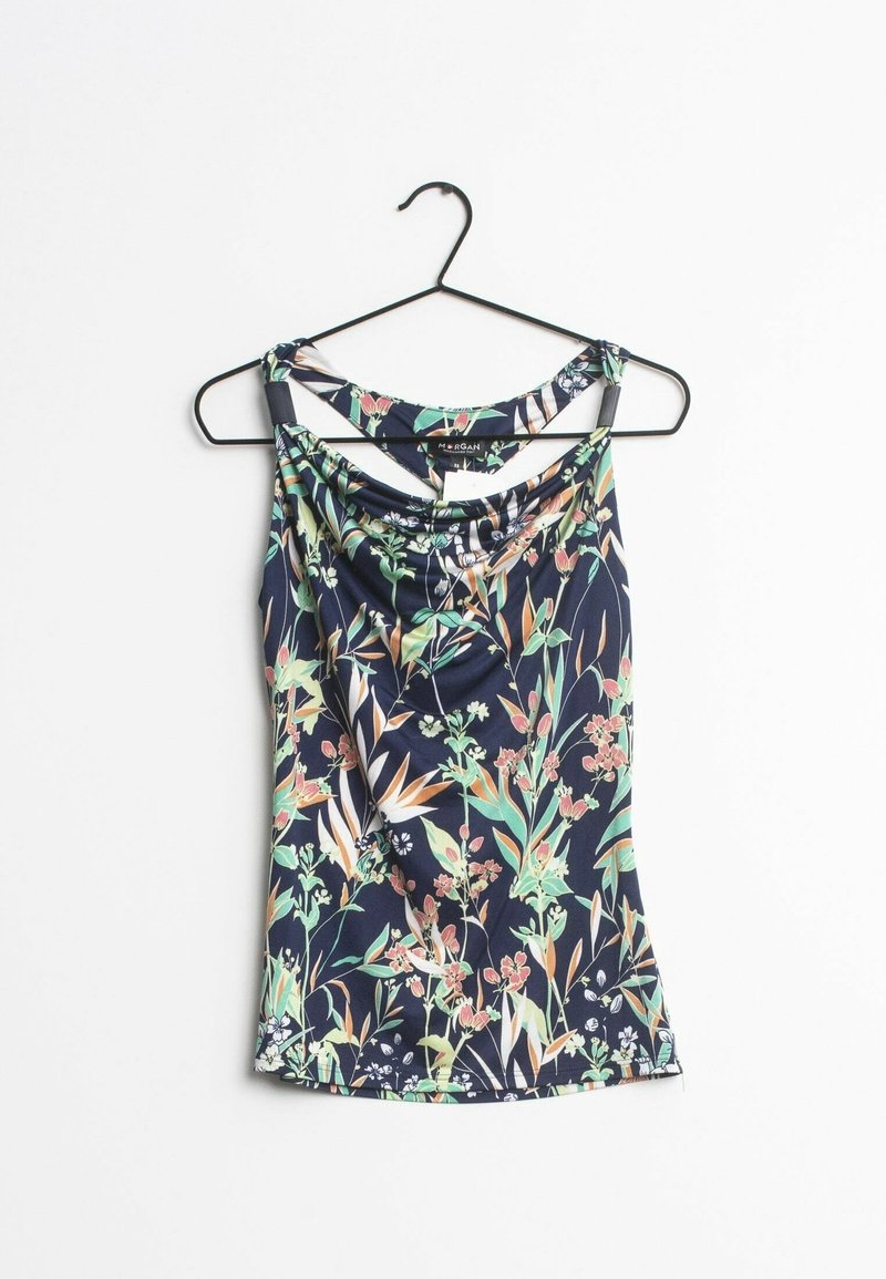 Haut sans manches bleu marine avec imprimé floral en vert, pêche et blanc, suspendu à un cintre en métal noir sur un fond blanc.