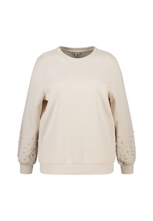 Beige sweatshirt met lange mouwen, ronde hals en textuurdetails. Mouwen zijn versierd met decoratieve kralen in verschillende maten. Zachte stofafwerking.