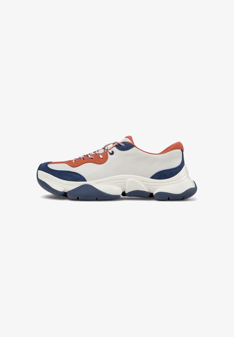 Sneakers with a white leather upper, orange and navy accents, multi-colored laces, and a thick navy rubber sole featuring textured grooves.