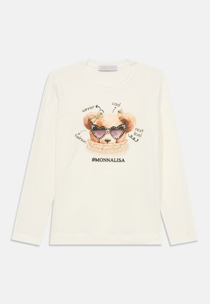 White long-sleeve shirt featuring a cartoon dog with sunglasses, surrounded by text. The collar is round, and the fabric appears soft.