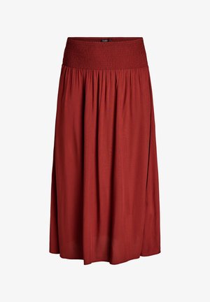 Midi suknja boje hrđe s širokim elastičnim pojasom i labavim, lepršavim materijalom skupljenim ispod struka za opušteni izgled.