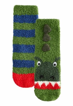 Grün und blau gestreifte Socken mit strukturiertem Material. Eine Socke zeigt das Gesicht eines Dinosauriers mit Augen, Zähnen und Stacheln; die andere hat Streifen.