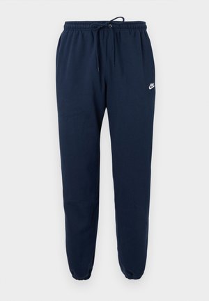 Pantaloni della tuta blu navy realizzati in tessuto morbido, con cintura elastica con coulisse e polsini elastici, con un piccolo logo Nike bianco.