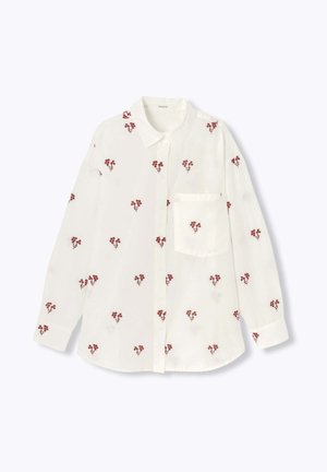 Chemise blanche à boutons avec broderie florale rouge sur l'ensemble, col classique, manches longues et une poche poitrine.
