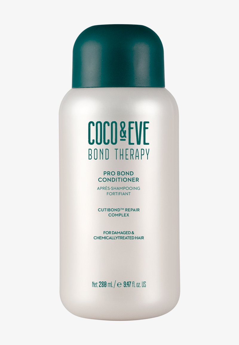 Odżywka Coco & Eve Bond Therapy Pro Bond w eleganckiej białej butelce z turkusową nakrętką. Zawiera 280 ml, przeznaczona do włosów zniszczonych i poddanych zabiegom chemicznym.