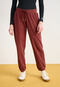 Bordauxfarbene Jogginghose aus strukturiertem Stoff, mit einem elastischen Bund und Kordelzug, tapered Säumen und Seitentaschen.