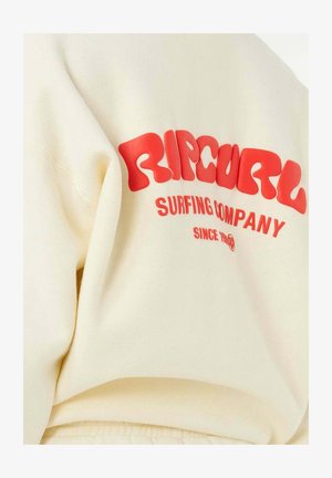 Roomkleurige hoodie met opvallende rode tekst "RIP CURL Surfing Company Since 1969" op de achterkant.
