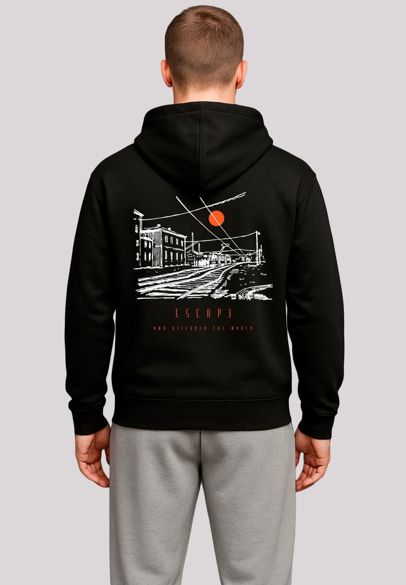Black hoodie featuring a white graphic design of a street scene with a sun, text “ESCAPE AND DISCOVER THE WORLD” in red. Cotton material.