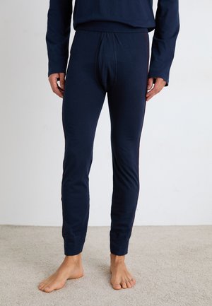 Marinblå långkalsonger med en åtsittande design, som har en ribbad midja och kontrasterande röda sidostrecken. Mjuk bomullsmaterial, minimal textur.