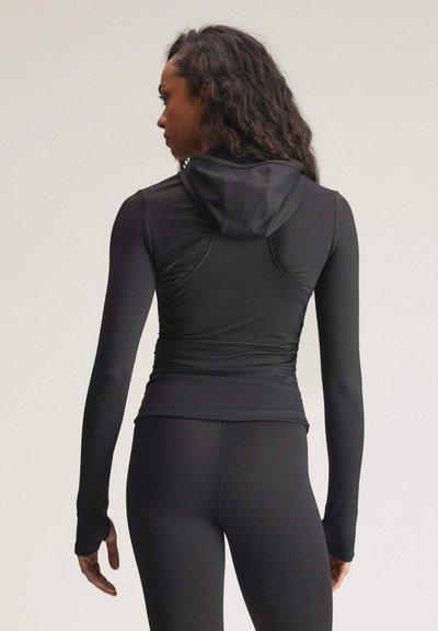 Black long-sleeve athletic top with a fitted design, hood, and textured paneling. Smooth fabric with thumbhole sleeves. Back view shown.