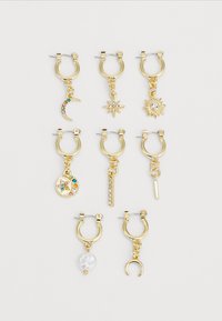 Gold hoop earrings with various charms: moon, star, sun, gemstone accents, and one with a pearl; textured and shiny finishes.