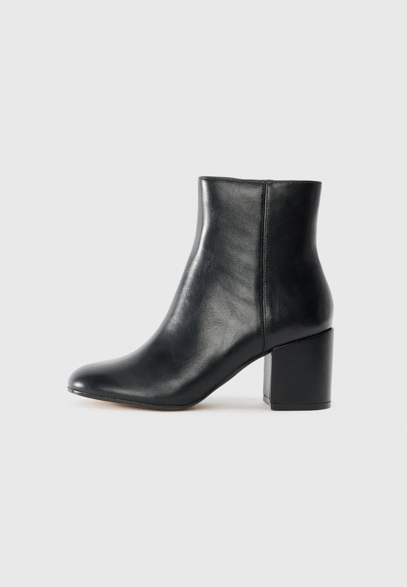 Black leather ankle boot with a rounded toe, mid-height block heel, smooth texture, and minimal seams for a sleek design.