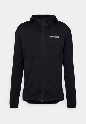Felpa nera Terrex con zip completa, maniche lunghe e cappuccio regolabile. Realizzata in tessuto testurizzato e leggero, con logo sul petto.