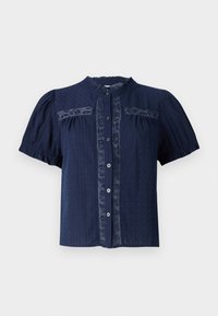 Marineblå kortermet bluse med teksturert stoff, som har blonde detaljer og en knapplukking foran med rund krage.