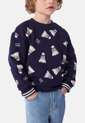Sweatshirt marine avec des motifs de volant en blanc, rouge et bleu. Manches et ourlet à côtes. Tissu en mélange de coton. Coupe standard.