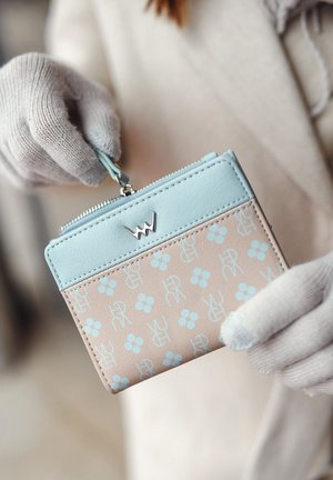 Light blue leather wallet with a beige patterned section featuring blue flowers and logos. Zipper closure with silver hardware accents.