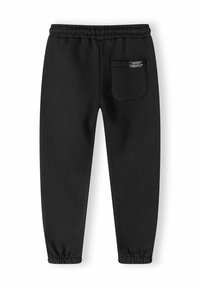 Schwarze Jogginghose aus weichem Material, mit einem elastischen Bund und Bündchen an den Knöcheln. Mit einer einzelnen Gesäßtasche mit einem Etikett.