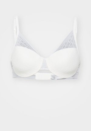 White bra with molded cups and intricate textured pattern. Transparent gray lace at top, adjustable straps, and clasp closure at back.