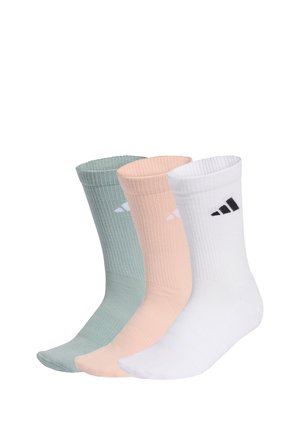 Trois chaussettes à côtes montantes en vert, pêche et blanc, chacune portant un petit logo noir et blanc près du haut.