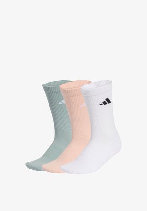 Tres calcetines de canalé con puño en verde, melocotón y blanco, cada uno con un pequeño logotipo en blanco y negro cerca de la parte superior.