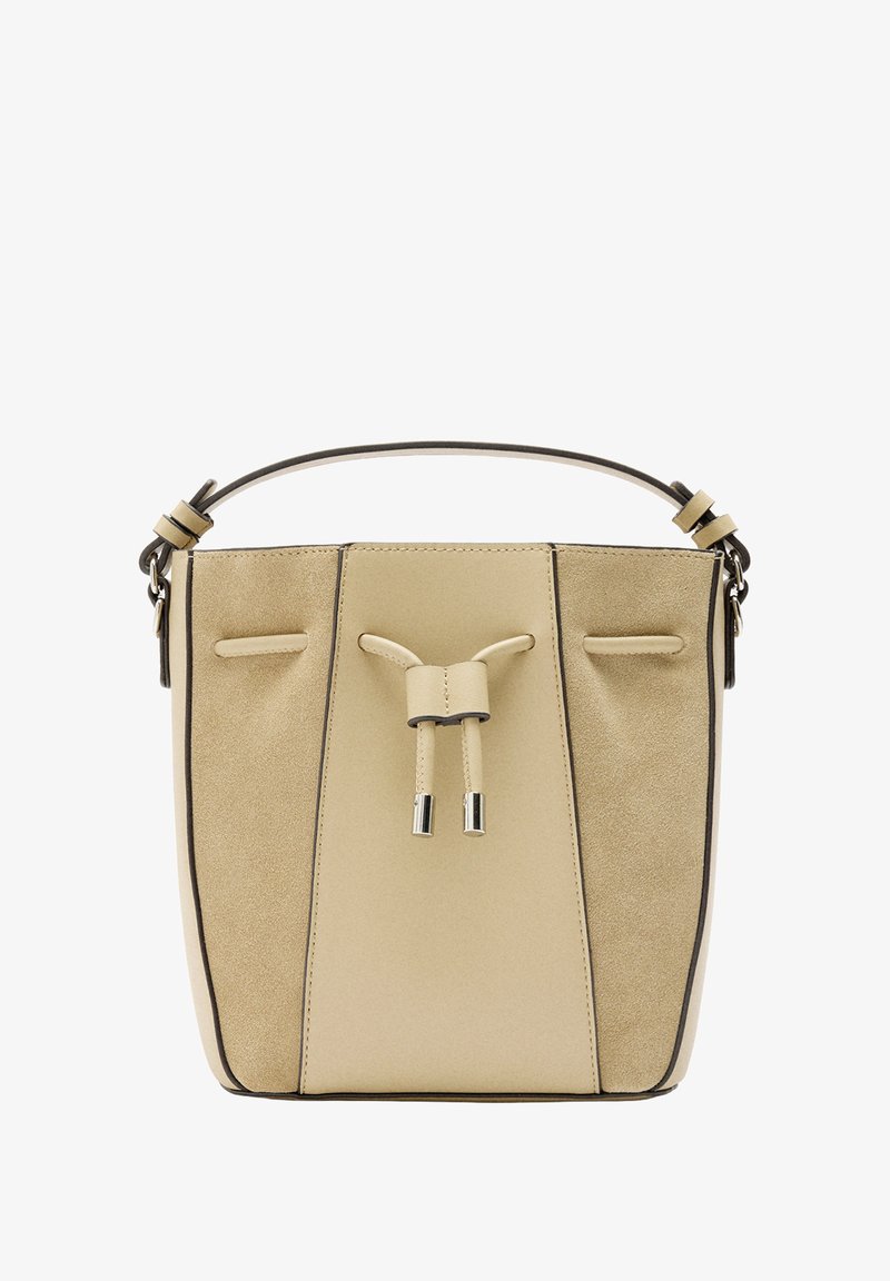 Beżowa torba typu bucket z gładką skórzaną powierzchnią, płaskim dnem i dwoma bocznymi kieszeniami. Posiada zapięcie na sznurek i metalowe akcenty.