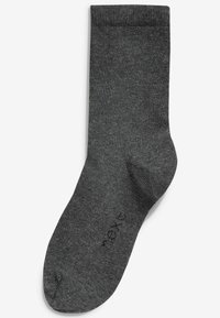 Chaussette en coton grise avec une texture côtelée, de hauteur moyenne, et un orteil renforcé. Présente un branding discret près de la cheville.